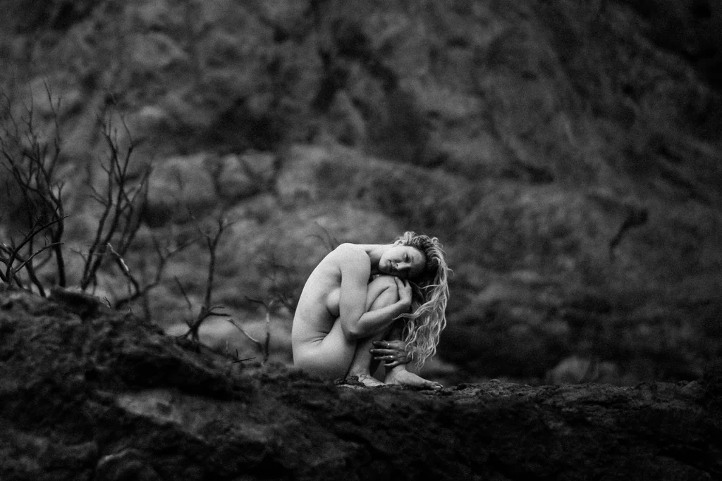 Black and white nude study among canyon rocks