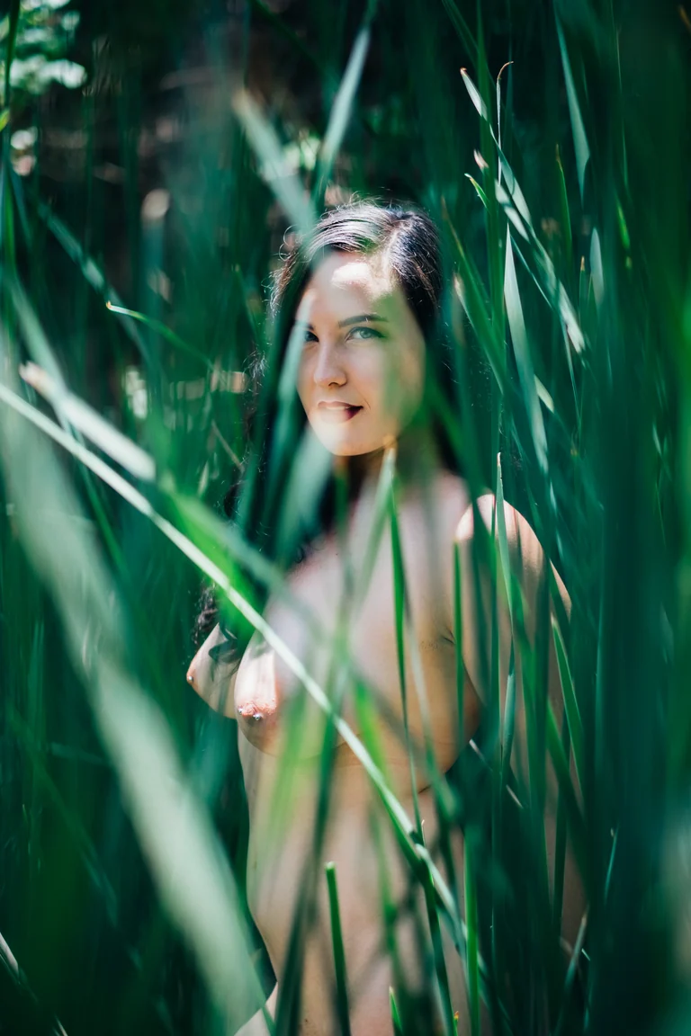 Figure laughing among tall green reeds