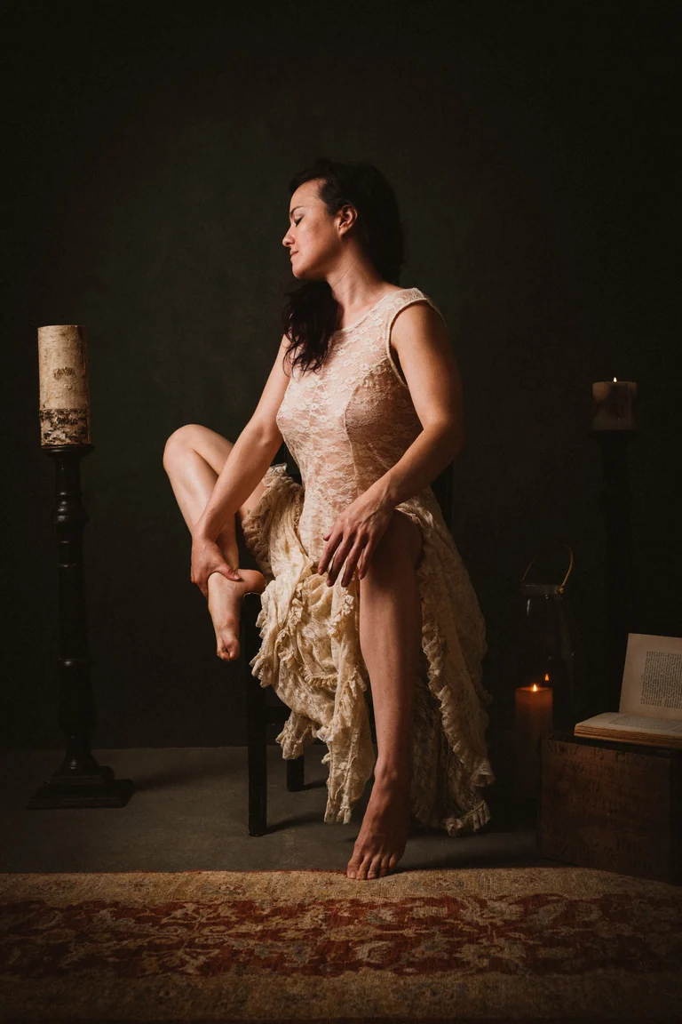 Woman in an ivory gown by candlelight